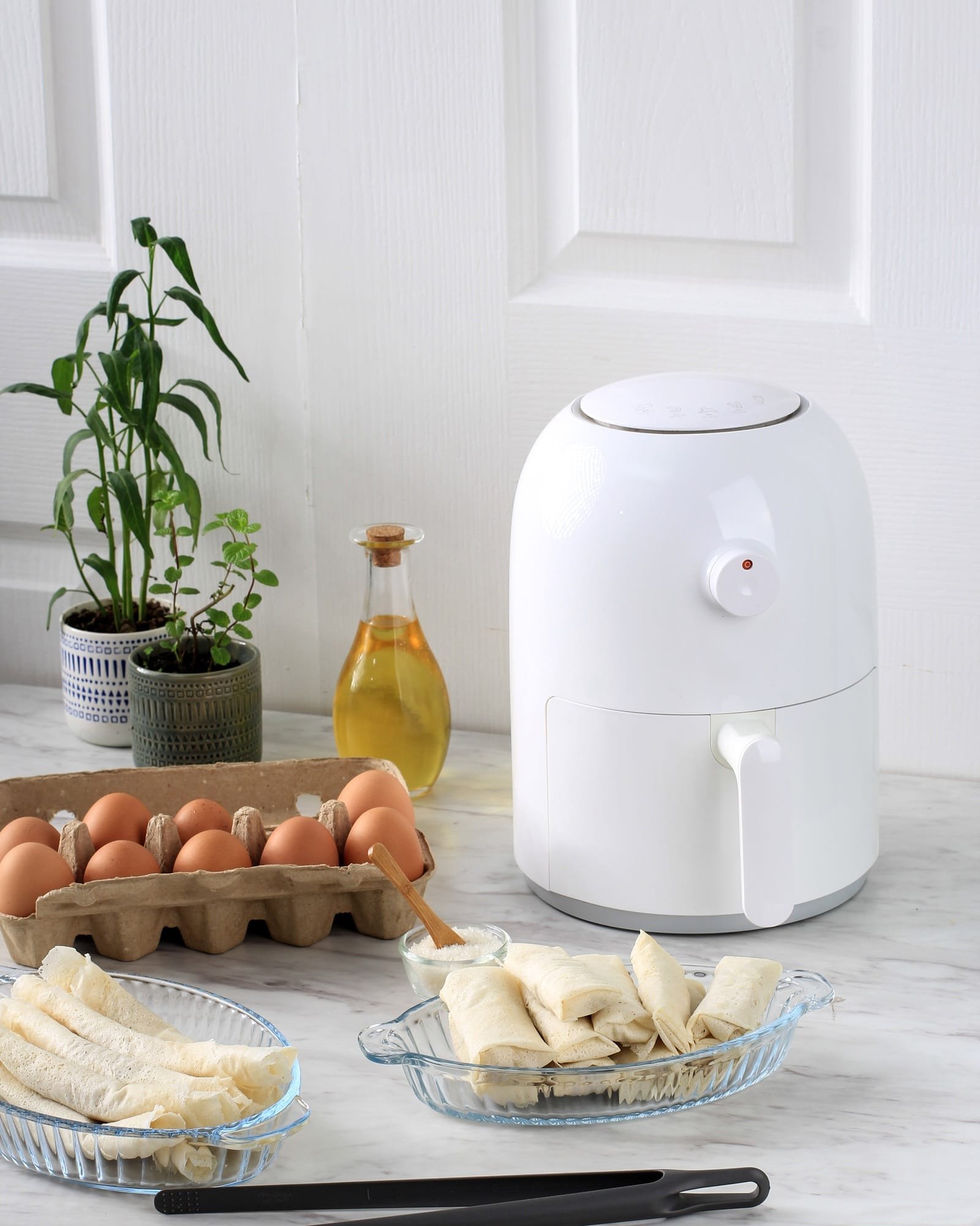 Cooking Process Using White Mini Air Fryer in the Kitchen.